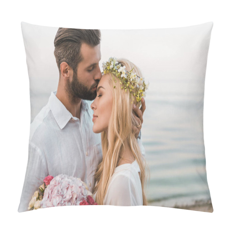Personality  side view of handsome groom kissing attractive bride forehead on beach pillow covers