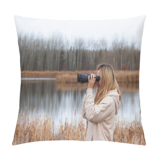 Personality  A Blond Caucasian Woman In Beige Coat Is Watching Through Binoculars In The Park Near The Lake In Late Autumn. Pillow Covers