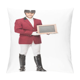 Personality  Smiling Young Horseman In Uniform Holding Blank Chalkboard And Looking At Camera Isolated On White Pillow Covers