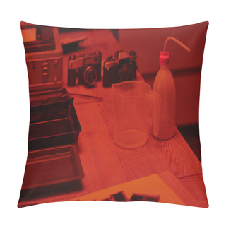 Personality  A Table With Analog Camera And Measuring Cup For Film Development In Darkroom With Red Light Pillow Covers