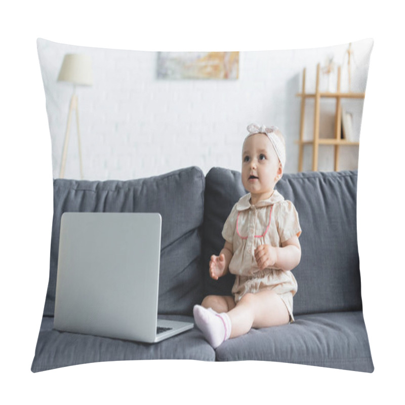 Personality  Toddler kid looking away near laptop on couch  pillow covers