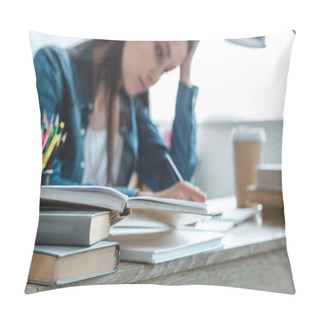 Personality  Close-up View Of Books On Desk And Girl Taking Notes Behind Pillow Covers
