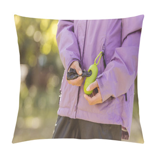 Personality  Cropped Shot Of Woman Holding Container With Bags For Cleaning After Pet In Park Pillow Covers