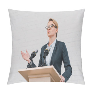 Personality  Beautiful Speaker Gesturing While Talking Near Microphones And Brick Wall  Pillow Covers