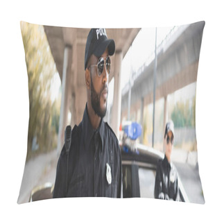 Personality  Serious African American Policeman Looking Away With Blurred Colleague On Background On Urban Street, Banner Pillow Covers