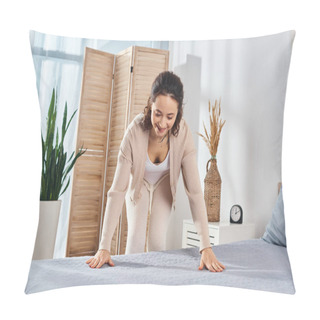 Personality  A Woman Stands Gracefully Over A Bed In A Bedroom, Making Blanket Wrinkles Pillow Covers