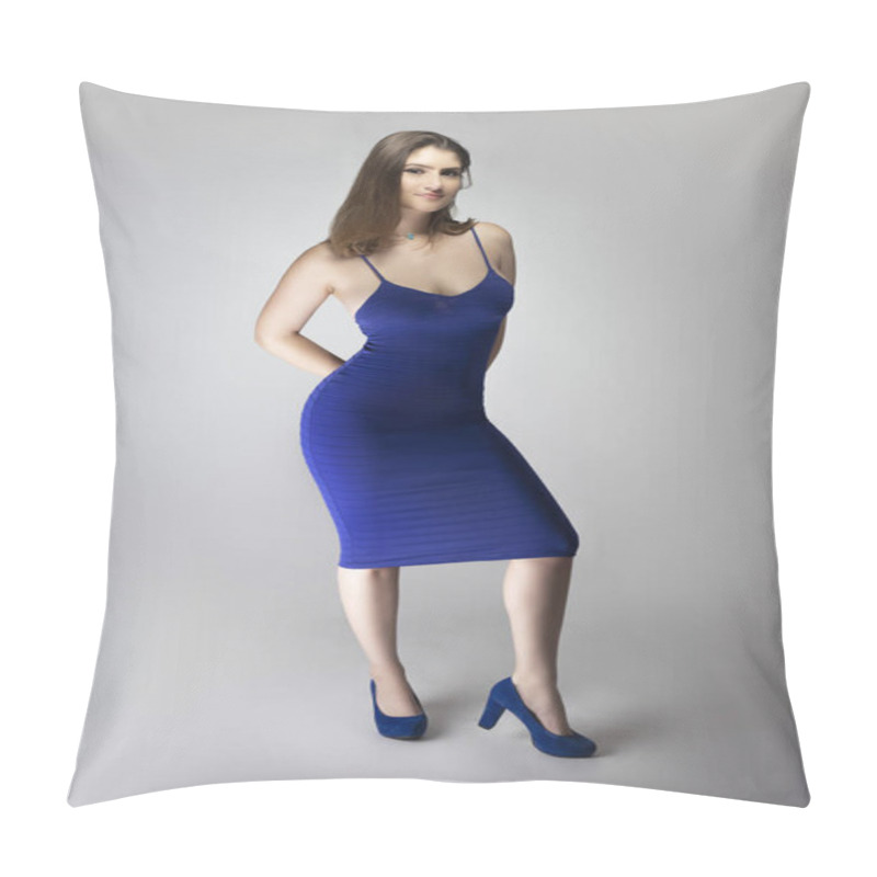 Personality  Catalog style studio shot of a Caucasian female fashion model wearing a navy or royal blue summer dress.  She is posing to show trendy style of the outfit or clothing pillow covers