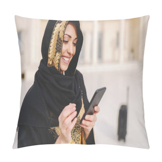 Personality  Portrait Of Charming Smiling Muslim Woman Dressed In Traditional Wear Using Smart Phone While Standing Outside. Pillow Covers