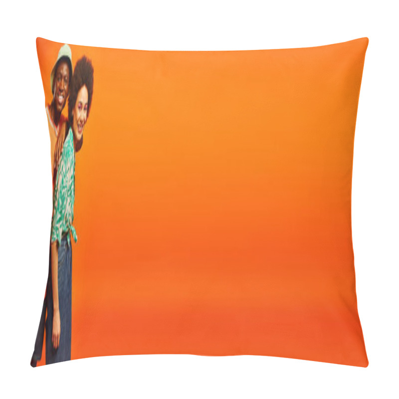 Personality  Pleased young african american man in panama hat and summer outfit looking at camera while standing near best friend with bold makeup isolated on orange, friends showcasing individual style, banner pillow covers