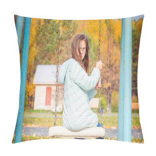 Personality  Cute Girl Dressed In Down Jacket Sitting On Swing On The Playground On Cool Autumn Day. Pillow Covers