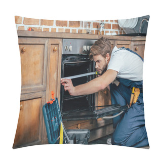 Personality  Young Repairman In Protective Workwear Measuring Oven With Tape  Pillow Covers