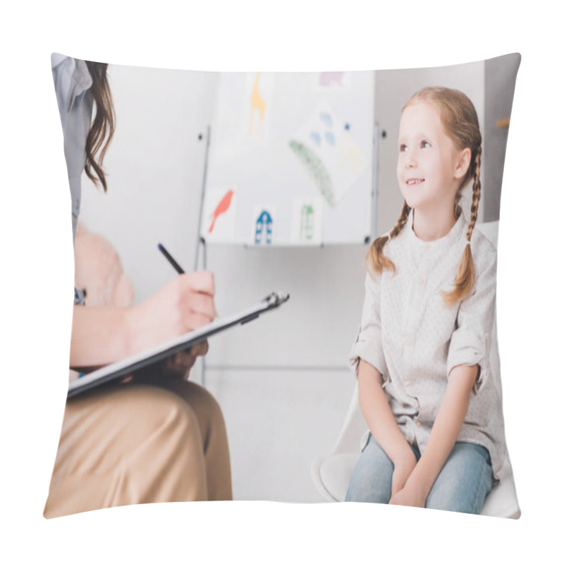 Personality  cropped shot of psychologist with clipboard sitting in front of child in office pillow covers