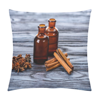 Personality  Bottles Of Natural Herbal Essential Oils, Carnation And Cinnamon Sticks On Wooden Table Pillow Covers