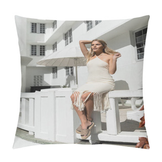 Personality  A Young, Beautiful Blonde Woman In A White Dress Sits Gracefully On A Ledge In Miami, Gazing Into The Distance. Pillow Covers