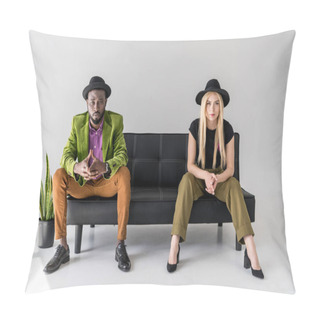 Personality  Multicultural Fashionable Couple In Hats Sitting On Black Sofa On Grey Backdrop Pillow Covers