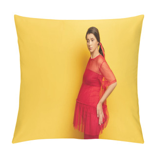 Personality  Worried Pregnant Woman In Red Tunic Touching Hip While Standing On Yellow Pillow Covers