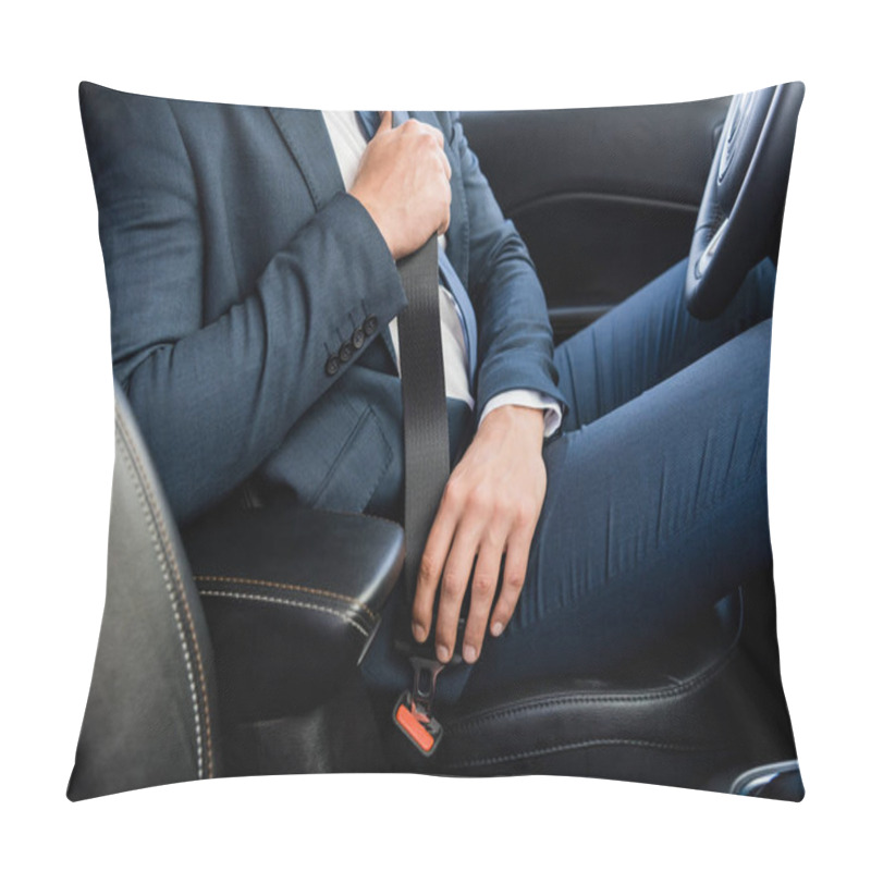 Personality  Cropped view of businessman locking seatbelt in car on blurred foreground pillow covers