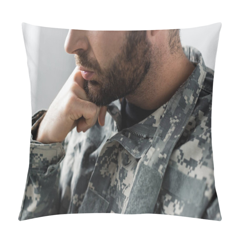 Personality  partial view of bearded military man in uniform holding hand near face pillow covers