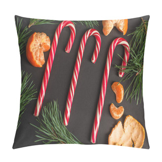Personality  Top View Of Striped Candy Canes Near Peeled Tangerines And Fir Branches On Black Pillow Covers