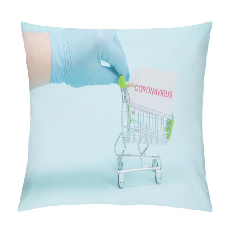 Personality  Cropped View Of Person In Latex Glove Holding Shopping Trolley With Coronavirus Lettering On Card On Blue Background Pillow Covers