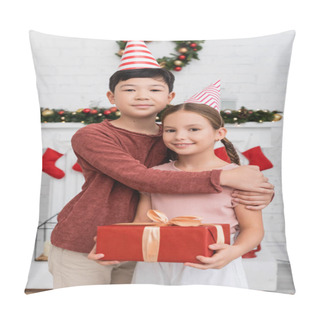 Personality  Asian Boy Hugging Friend In Party Cap Holding Gift Box Near Blurred Christmas Decor At Home  Pillow Covers