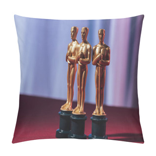 Personality  KYIV, UKRAINE - JANUARY 10, 2019: Selective Focus Of Golden Oscar Award Statuettes With Purple Background Pillow Covers