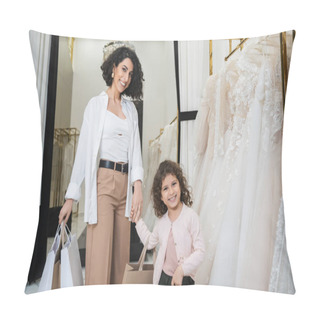 Personality  Cheerful Middle Eastern Bride With Brunette Hair In Beige Pants With White Shirt Holding Shopping Bags While Standing With Little Girl Near Wedding Dresses In Bridal Salon, Mother And Daughter  Pillow Covers