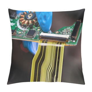 Personality  Flat Plastic Strip Flexible Cable On Printed Circuit Board On A Dark Background. Hand In Blue Glove Holding Green PCB With Integrated Motor Stator And Electronic Components As Micro Chip Or Resistors. Pillow Covers