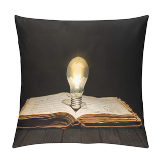 Personality  Vintage Book With Light Bulb On Wooden Table With Dark Text Space. Pillow Covers