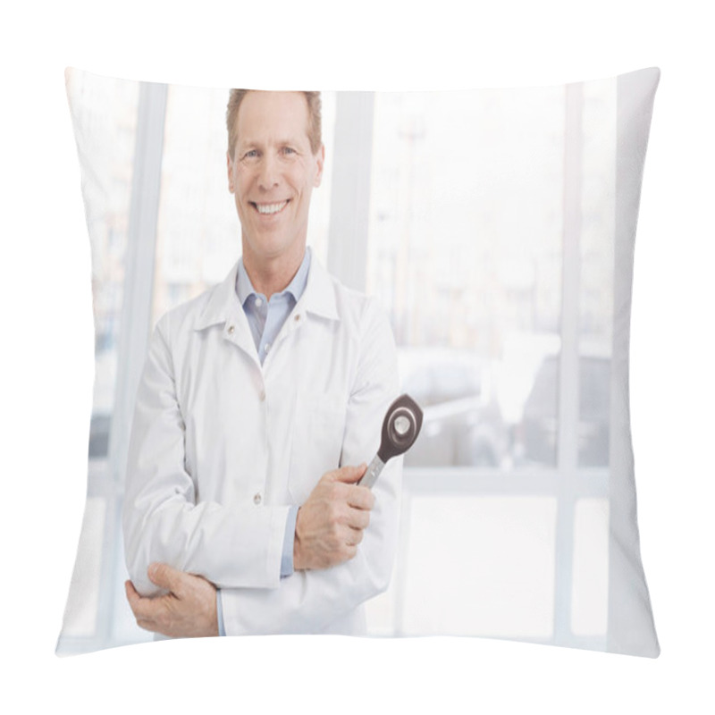Personality  Delighted senior practitioner holding professional instrument at work pillow covers