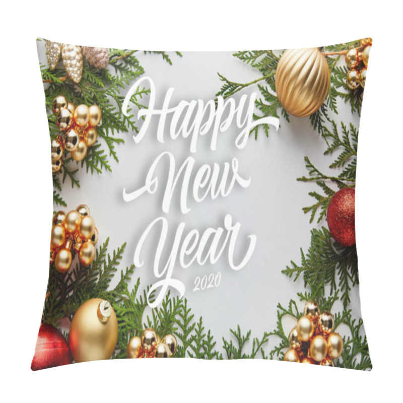 Personality  frame of shiny golden and red Christmas decoration on green thuja branches isolated on white with happy new year lettering pillow covers