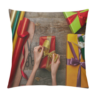 Personality  Cropped Shot Of Woman Tying Ribbon On Wrapped Christmas Present On Wooden Surface With Other Gifts  Pillow Covers