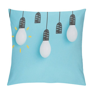 Personality  Close Up View Of White Lamps Pretending Hanging On Lamp Holders Isolated On Blue Pillow Covers