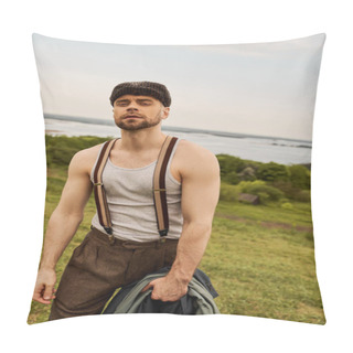 Personality  Portrait Of Fashionable And Bearded Man In Suspenders And Newsboy Cap Holding Jacket And Looking At Camera While Standing With Blurred Landscape At Background, Fashion-forward In Countryside Pillow Covers