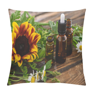 Personality  Sunflower, Chamomile Flowers And Bottles With Essential Oils On Wooden Surface Pillow Covers