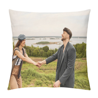 Personality  Positive And Fashionable Brunette Woman In Newsboy Cap And Vest Holding Hand Of Bearded Boyfriend In Jacket While Standing With Scenic Landscape At Background, Fashionable Couple In Countryside Pillow Covers