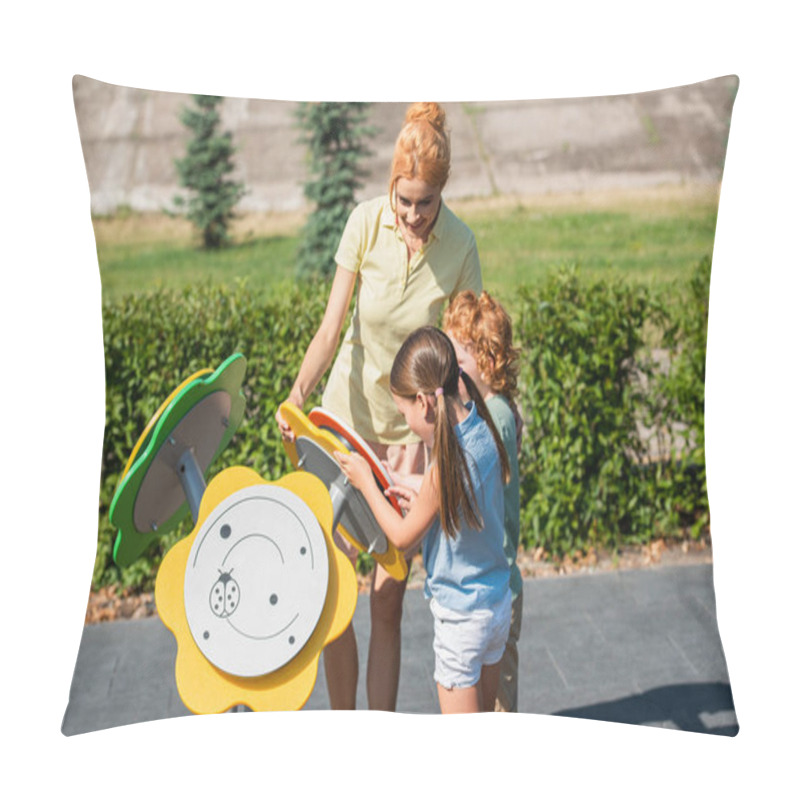 Personality  kids playing with toy flowers near happy mom outdoors pillow covers