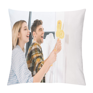 Personality  Happy Young Couple Painting White Wall In Yellow With Paint Rollers Pillow Covers