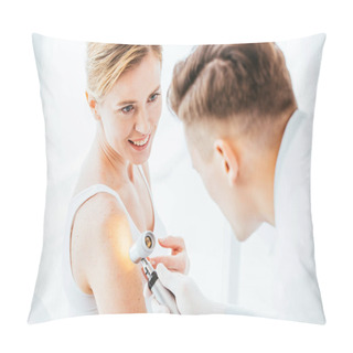 Personality  Selective Focus Of Cheerful Woman Looking At Dermatologist Holding Dermatoscope While Examining Hand  Pillow Covers