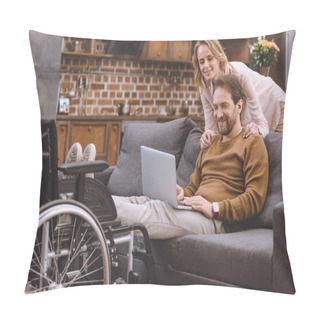 Personality  Happy Woman Looking At Disabled Husband Putting Legs On Wheelchair And Using Laptop At Home Pillow Covers