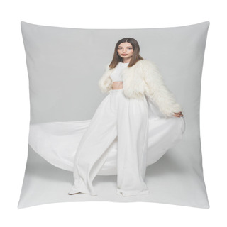 Personality  Full Length Of Trendy Woman In Totally White Outfit And Faux Fur Jacket Standing On Grey Pillow Covers