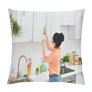 Personality  A Stylish Woman In Casual Attire Methodically Scrubs The Kitchen Sink With A Vibrant Green Rag, Bringing Radiant Cleanliness. Pillow Covers