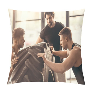 Personality  Side View Of Muscular Sportsmen Lifting Tyre Together In Gym Pillow Covers