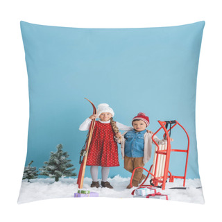 Personality  Child In Winter Outfit Holding Skis And Hugging Boy Standing Near Sleight Isolated On Blue  Pillow Covers