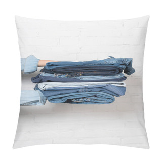 Personality  Partial View Of Woman Holding Stack Of Blue Denim Clothes Near White Brick Wall Pillow Covers