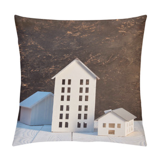 Personality  Houses Models On White Wooden Table Near Brown Textured Wall, Real Estate Concept Pillow Covers