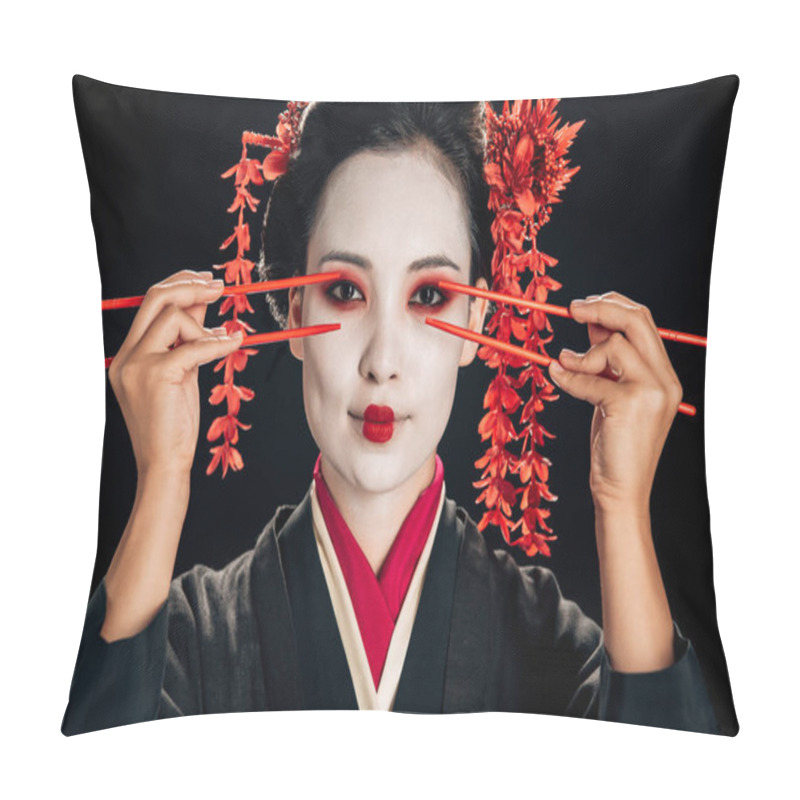 Personality  beautiful geisha in black kimono with red flowers in hair holding chopsticks near eyes isolated on black pillow covers