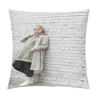 Personality  Young Woman With Makeup, Blonde Hair, Bangs, In Stylish Outfit, Long Hoodie, Coat, Black Leather Pants And Beige Boots Standing Near Grey Brick Wall Of Modern Building And Looking Away  Pillow Covers