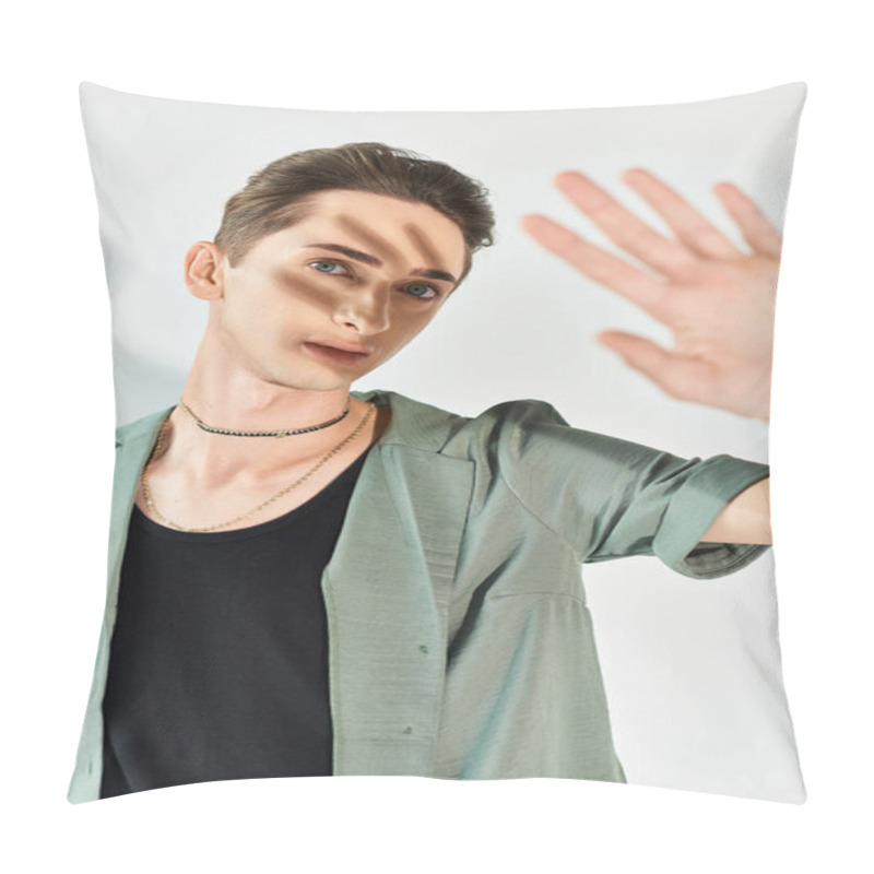 Personality  A Young Queer Man In A Green Shirt Strikes A Hand Gesture, Showcasing Pride And Individuality In A Studio Setting On A Grey Background. Pillow Covers