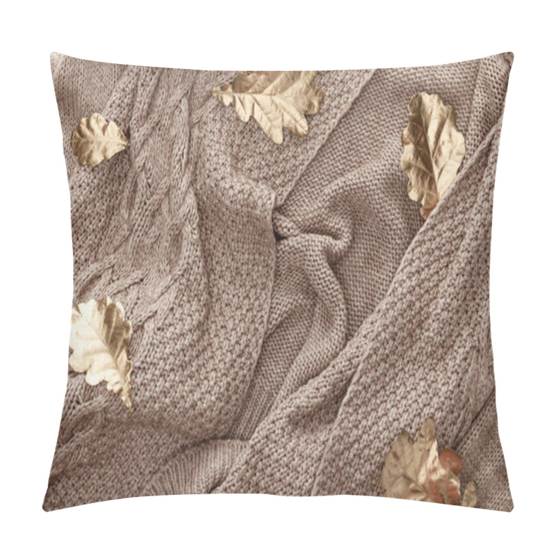 Personality  top view of golden foliage scattered on knitted brown sweater pillow covers